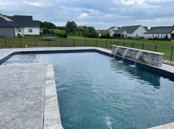 Inground gunite pool with stacked stone water features